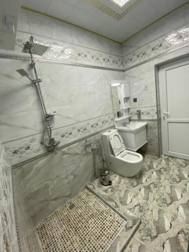 a bathroom with a toilet and a sink at Dreamed Villa In Gabala in Gabala