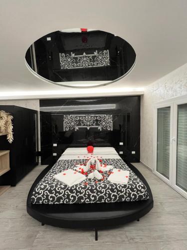 a bedroom with a large bed with a black bed frame at Vista Mare Apartments in Giardini Naxos