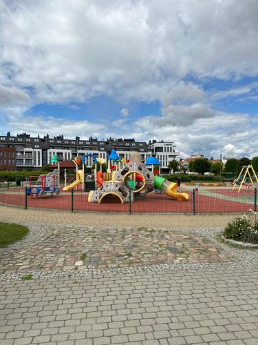 a playground with a water park with a slide at Apartament Widokowy Zamkowa in Tczew