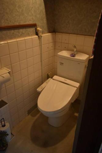 a bathroom with a white toilet in a room at 【利灸ゲストハウス】3 mins walk to Kyoto station! Unique house！ in Kyoto