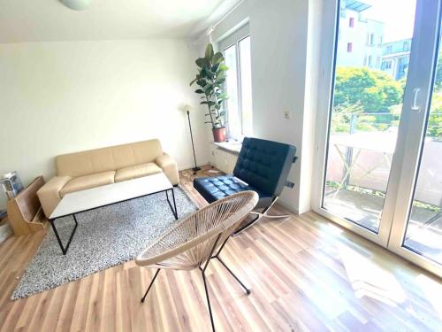 a living room with a couch and two chairs at BER, Quiet, Green, View, near Terminal, Berlin parking in Schönefeld