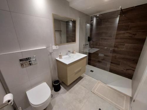 a bathroom with a toilet and a sink and a shower at LOFT Deluxe Cumbre del Mar in El Campello