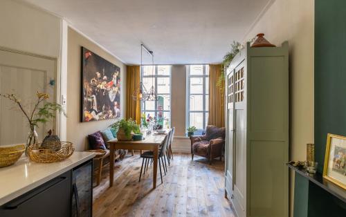 een woonkamer met een tafel en een eetkamer bij Rijksmonument het Telmerck Zutphen in Zutphen