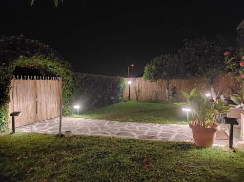 a garden at night with lights in the grass at The Cozy Garden Villa 