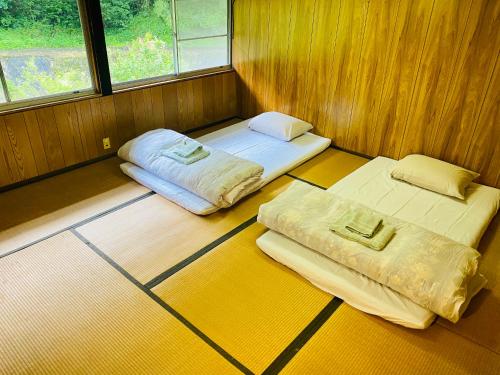 Giường trong phòng chung tại Yubara Hot Springs - Entire Home, Relaxing River Access, Families Welcome