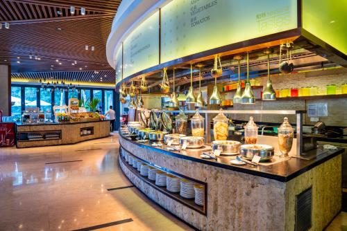 a restaurant with a counter with food on it at The Westin Sanya Haitang Bay Resort in Sanya