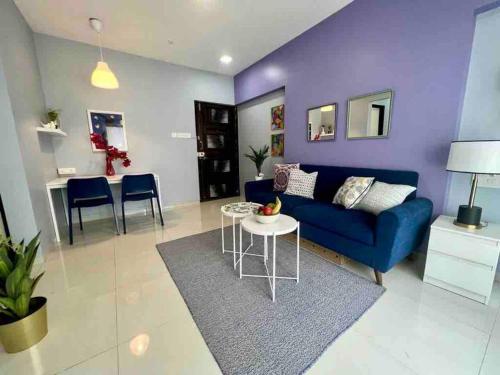 a living room with a blue couch and a table at Pali Carters Building 801, 20th Road, Khar West by Connekt Homes in Mumbai