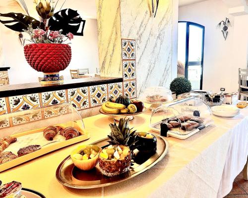a table with a bunch of food on it at La Collina sul Mare in Palma di Montechiaro
