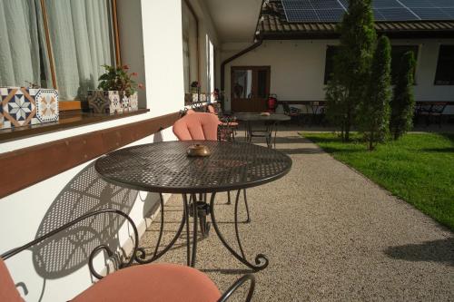 a black table and chairs sitting on a patio at Pensiunea Sibiel in Sibiel