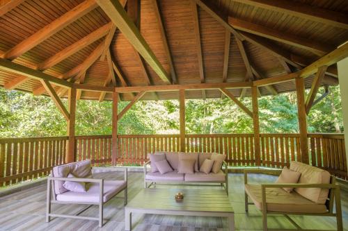 a screened in porch with two chairs and a table at Pensiunea Sibiel in Sibiel
