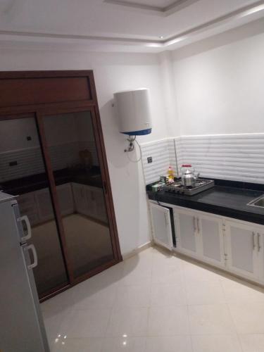 a kitchen with a sink and a counter top at Ouma yanis in Kenitra