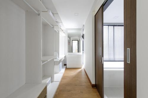 a hallway with white cabinets and a window at Modern villa with pool close to the beach - LP #97 in Phuket Town