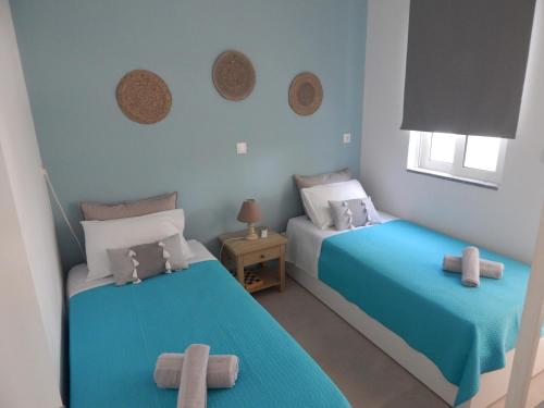 a bedroom with two beds with crosses on them at Pervoli in Faliraki