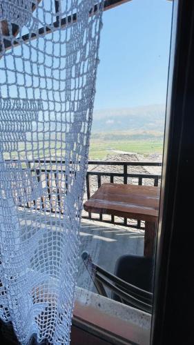 a view from a window of a table and a bench at Denis GuestHouse 1930 in Gjirokastër