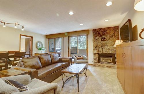 a living room with a couch and a fireplace at Cm336 Copper Mtn Inn Condo in Copper Mountain