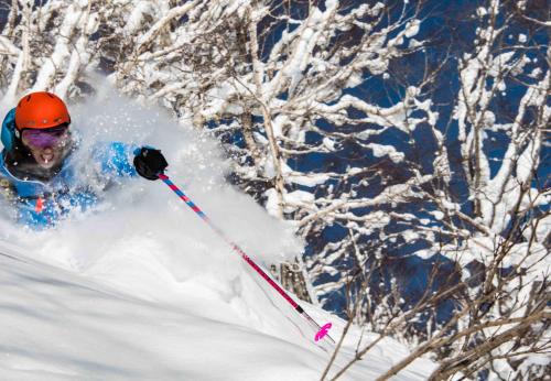 a person is skiing down a snow covered slope at Morino Lodge - Myoko in Myoko