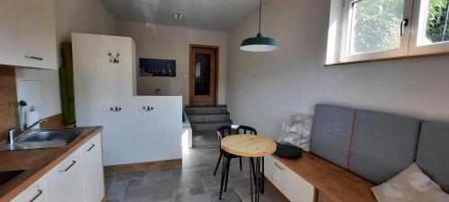 a kitchen with a table and a small table in a room at Kleine Ferienwohnung für Zwei zwischen Allgäu und Bodensee 