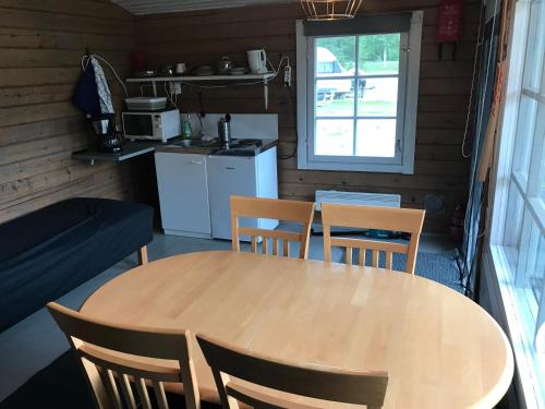 a table and chairs in a room with a kitchen at Arctic Camping Finland in Pello