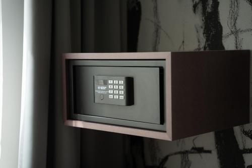 a microwave is attached to a wall at Hotel Grille in Erlangen