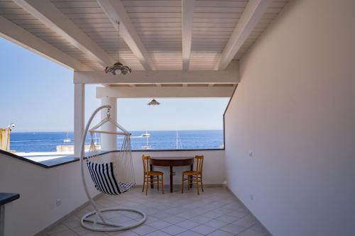 a view from the balcony of a house with a table and chairs at Casa Lussu in Lipari