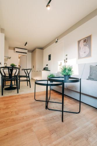 a living room with two tables and a couch at Athesense Suites in Athens