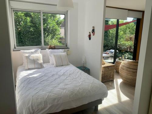 Postel nebo postele na pokoji v ubytování Bungalow parenthèse de vie - logement indépendant