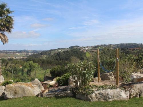 uma rede num jardim com pedras e árvores em Villa with private wellness and pool em Salir de Matos