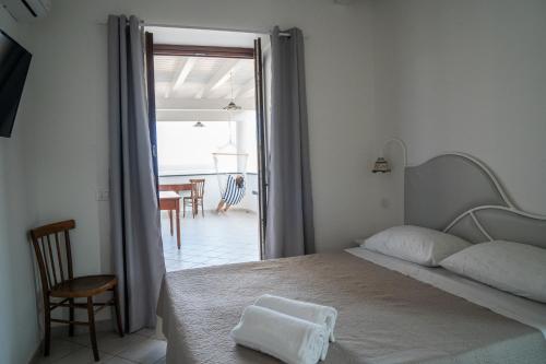 a bedroom with a bed and a door to a patio at Casa Lussu in Lipari