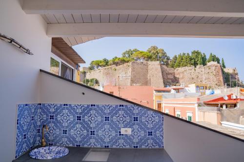 a balcony with blue and white tiles on the wall at Casa Lussu in Lipari