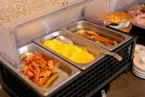 a tray of food with carrots and other foods at Hotel Südblick in Norderney