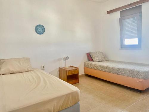 a bedroom with two beds and a small bed and a window at İncebel in Dalaman