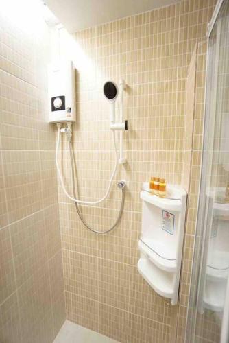 a bathroom with a shower and a toilet in it at Maruay Living Apartment 509 (Khaosan/Chinatown/Samyot MRT) in Bangkok