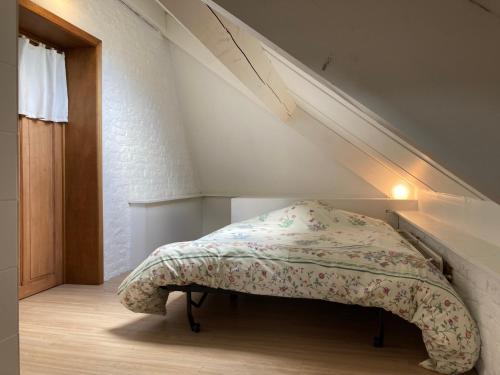 a bedroom with a bed with a blanket on it at La Ferme Saint Pierre de Glabais in Genappe