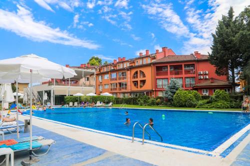 a large swimming pool with people in a hotel at Oasis dream apartment with pool by the sea in Nesebar