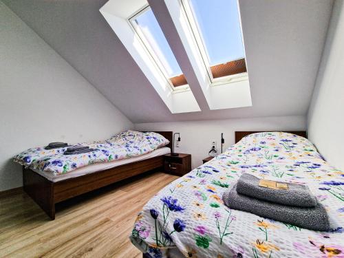 a bedroom with two beds and a skylight at GraVelo - Noclegi in Bartkowa-Posadowa