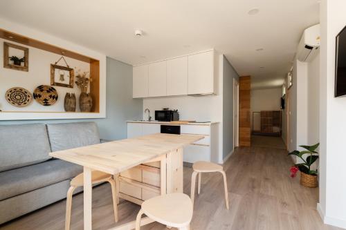 a kitchen and living room with a table and a couch at VILLA DOS R'S in Avis