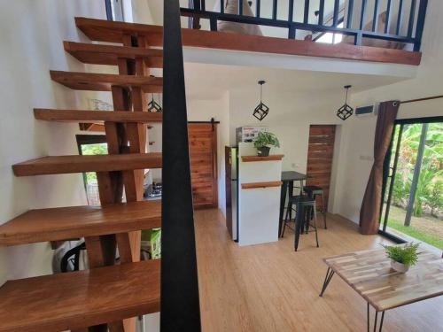 a living room with a staircase in a house at S&S House in Srithanu