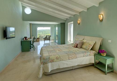 a bedroom with a bed and a television in it at Gato Preto de Silves - Adults Only in Silves