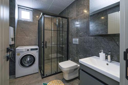 a bathroom with a washing machine and a washer at Palmiye Apart Hotel in Antalya