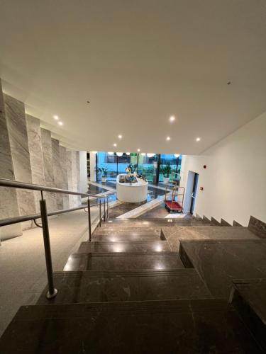 a staircase in a building with a boat in the distance at Apartament Astria Olimp in Olimp
