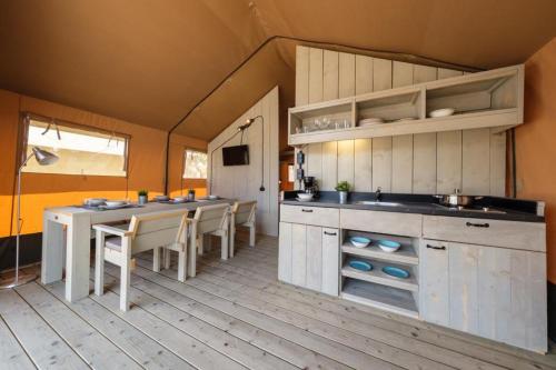 a kitchen and dining room with a table and chairs at Devesa Gardens in El Saler