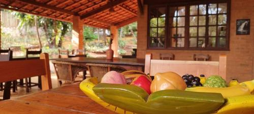 a bowl of fruits and vegetables on a table at Pousada Luar do Sertão in Lençóis