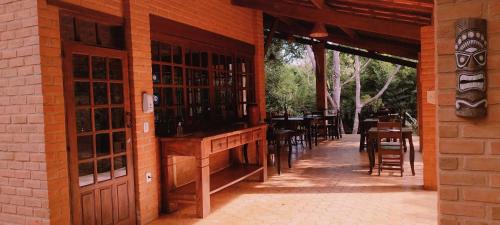 a restaurant with tables and chairs in a building at Pousada Luar do Sertão in Lençóis