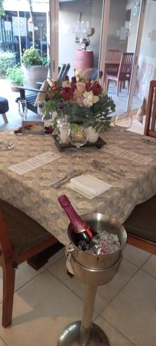 a table with a bunch of glasses of wine on it at Cinnamon Boutique Guest House in Wilderness