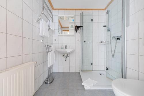 a bathroom with a shower and a sink and a toilet at Haus Salweyblick in Niedersalwey