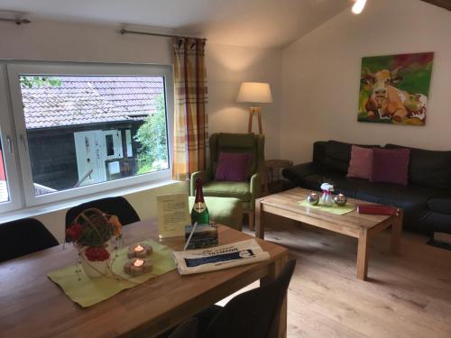 a living room with a couch and a table at Landhaus Kraehenberg in Niedersalwey