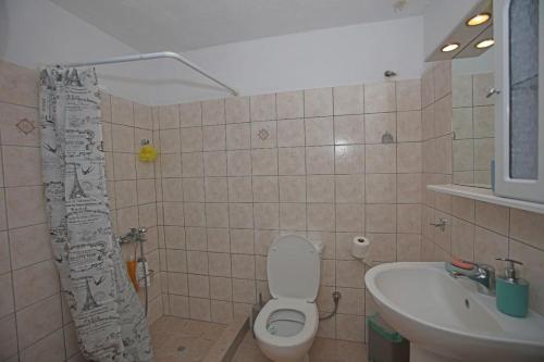 a bathroom with a toilet and a sink at Paraporti Room 2 in Andros