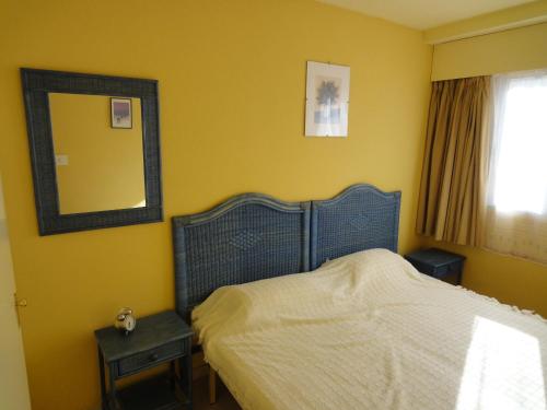 a bedroom with a bed with a mirror and a window at Jardin Calpe Apartment in Calpe