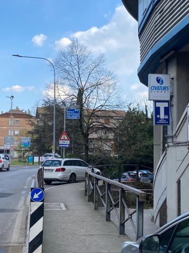 a street with cars parked next to a building at Casa Valentina 1 in Perugia