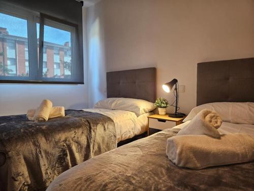 a bedroom with two beds with a teddy bear on the bed at 633A Colloto, 3 dorm. y garaje in Santa Eulalia